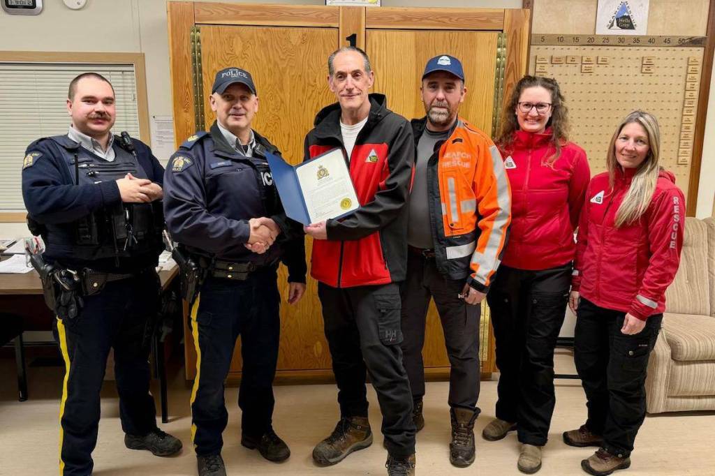 (L-r) RCMP Cst. Karl Maibauer and Sgt. Grant Simpson on March 9, 2026 present a certificate of appreciation to local search and rescue personnel for the rescue and evacuation of an injured hiker. Receiving the award are Wade Conroy and Marc Tremblay, search managers for Wells Gray Search and Rescue and Barriere Search and Rescue, respectively, as well as Maxine Cusack and Tanya Chapman, the search and rescue volunteers who found the hiker and administered first aid. The incident occurred Dec. 1 on the Clearwater River Trail. (Submitted by Wells Gray Search and Rescue)